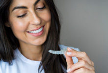 a patient smiling and admiring her Spark clear aligner