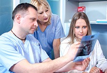 Dentist and patient reviewing x-ray together