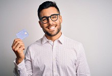 Smiling man holding a payment card