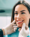 patient smiling while visiting cosmetic dentist 